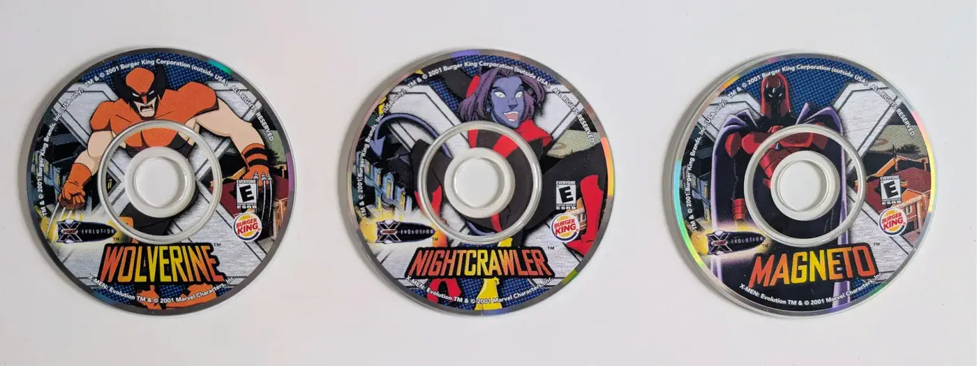 Three Burger King X-Men Evolution promotional mini CDs: Wolverine, Nightcrawler, and Magneto.